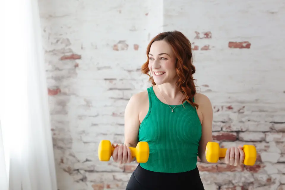 Fit woman in workout attire demonstrating a strength exercise (promotional fitness image)
